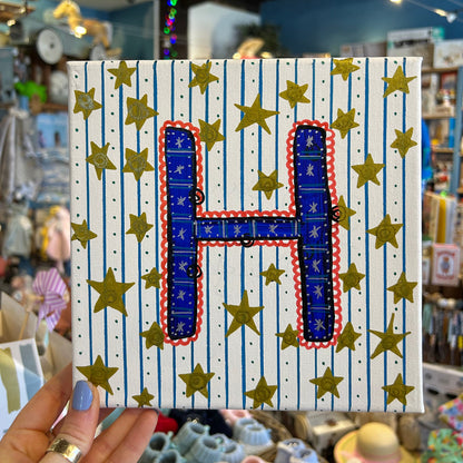 Close-up detail of the textured, multi-dimensional layered paint technique on the H. Sloan & Daughter monogram canvas.