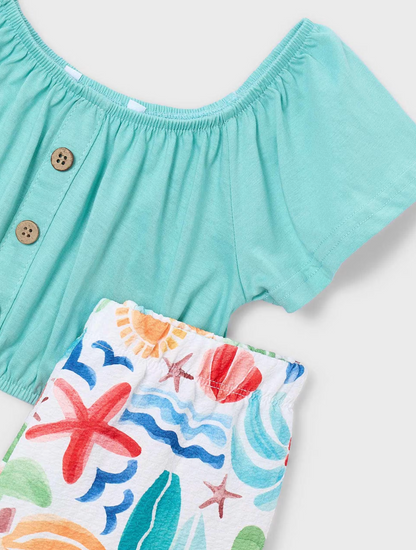 Close-up view of the vibrant tropical botanical print and premium lightweight fabric of the girls summer outfit.