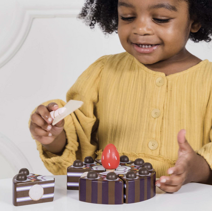 The Le Toy Van chocolate gateau toy cake styled beautifully as a high-quality educational gift for a children's playroom.