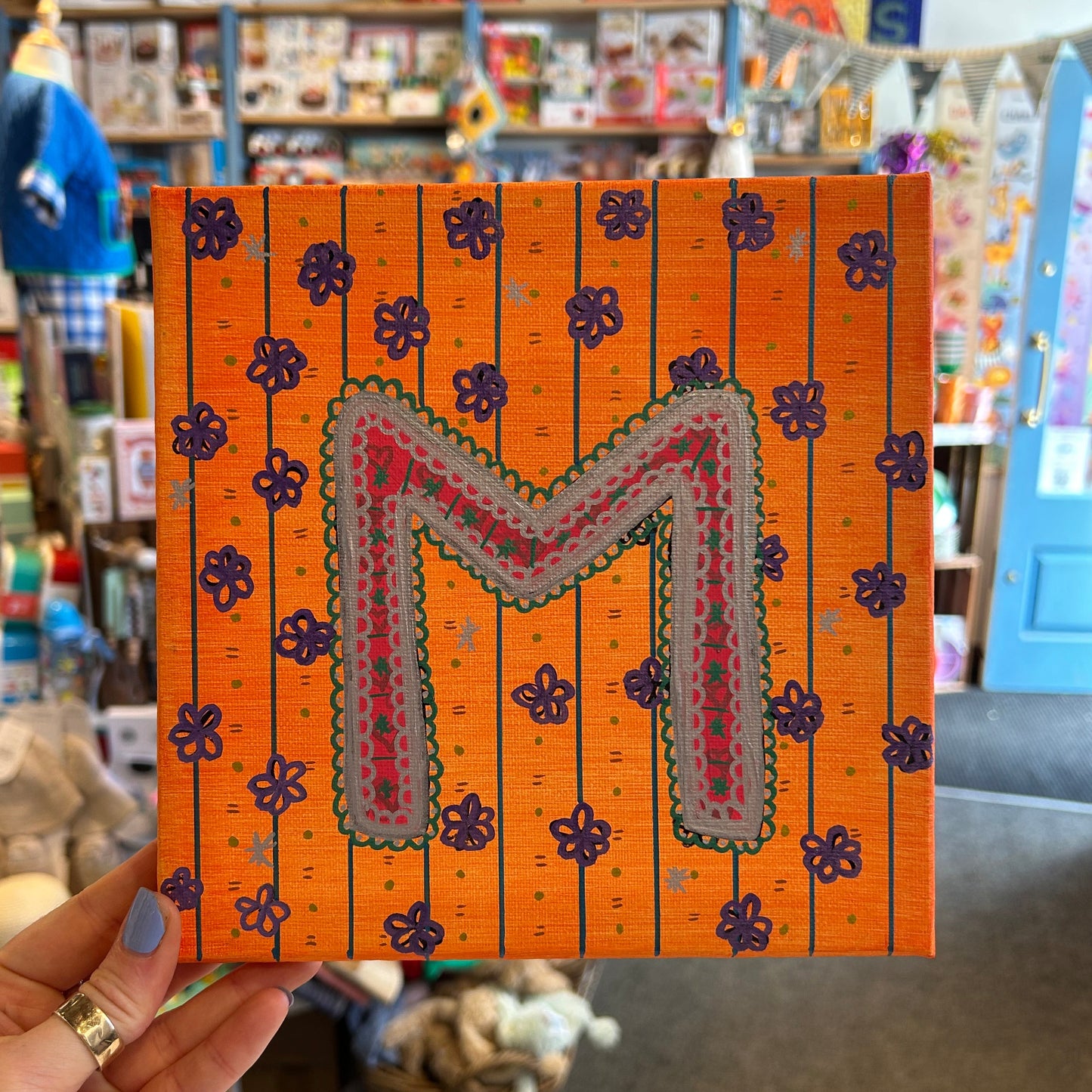 Close-up detail of the textured, multi-dimensional layered paint technique on the M. Sloan & Daughter monogram canvas.