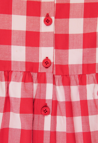 Close-up view of the premium organic woven cotton gingham check fabric and gathered waistline.