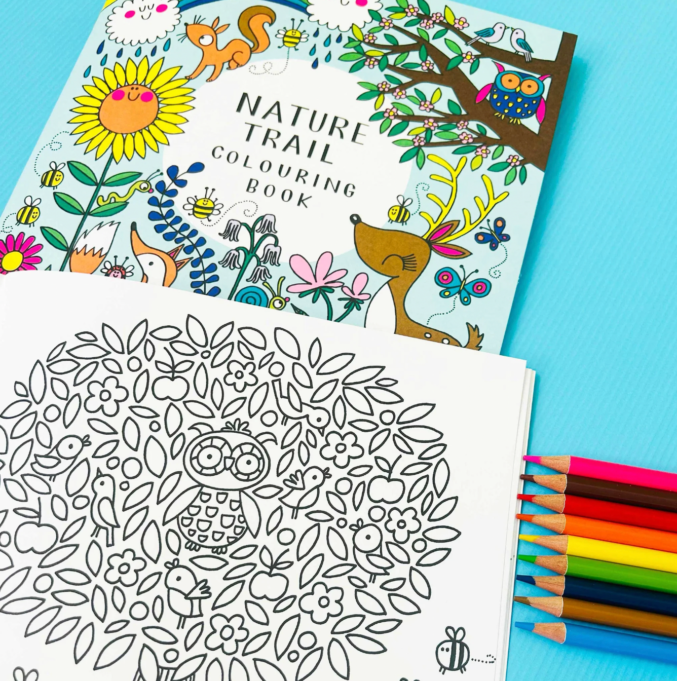 Nature-themed coloring book with a completed coloring page and colored pencils. Rachel Ellen Nature Trail Colouring Book | Annabel's of Cranbrook