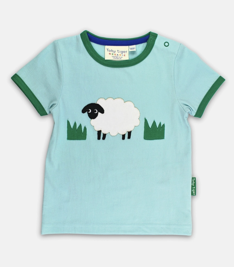 Toby Tiger organic cotton short-sleeved t-shirt in light blue featuring a cute sheep appliqué with green trim.