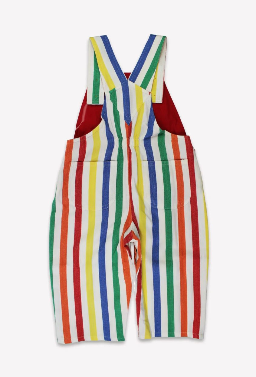 Close-up view of the adjustable button shoulder straps and woven chest pocket on the Toby Tiger striped dungarees
