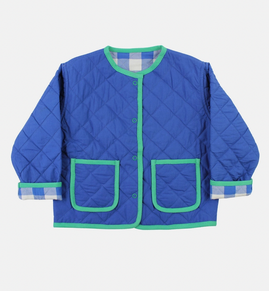 The reversed solid blue side of the Toby Tiger organic kids jacket showing the handy front pockets and snap fasteners.