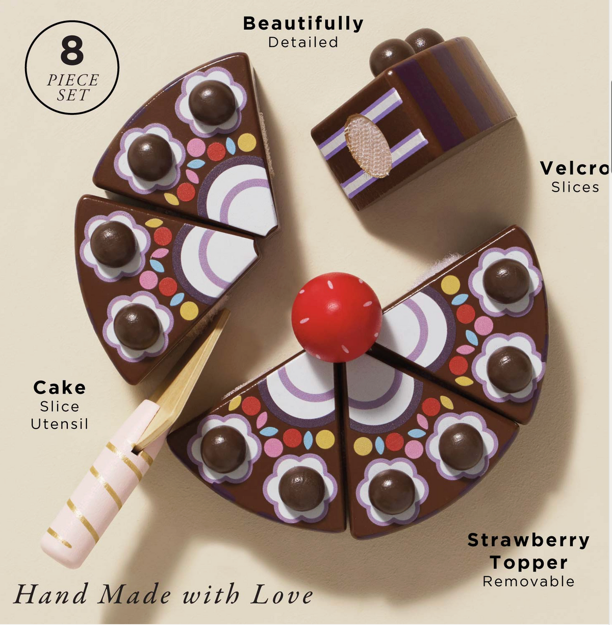 A wooden cake server cutting a slice from the Le Toy Van toy chocolate gateau, showcasing the velcro attachments.